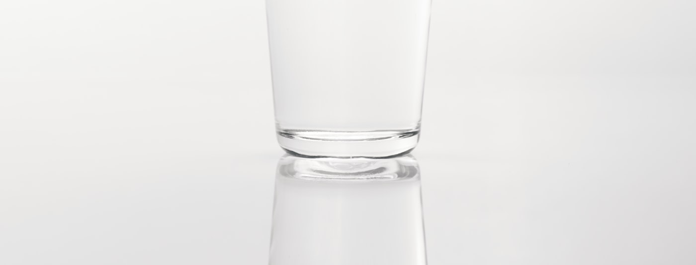 A glass of water on a reflective surface